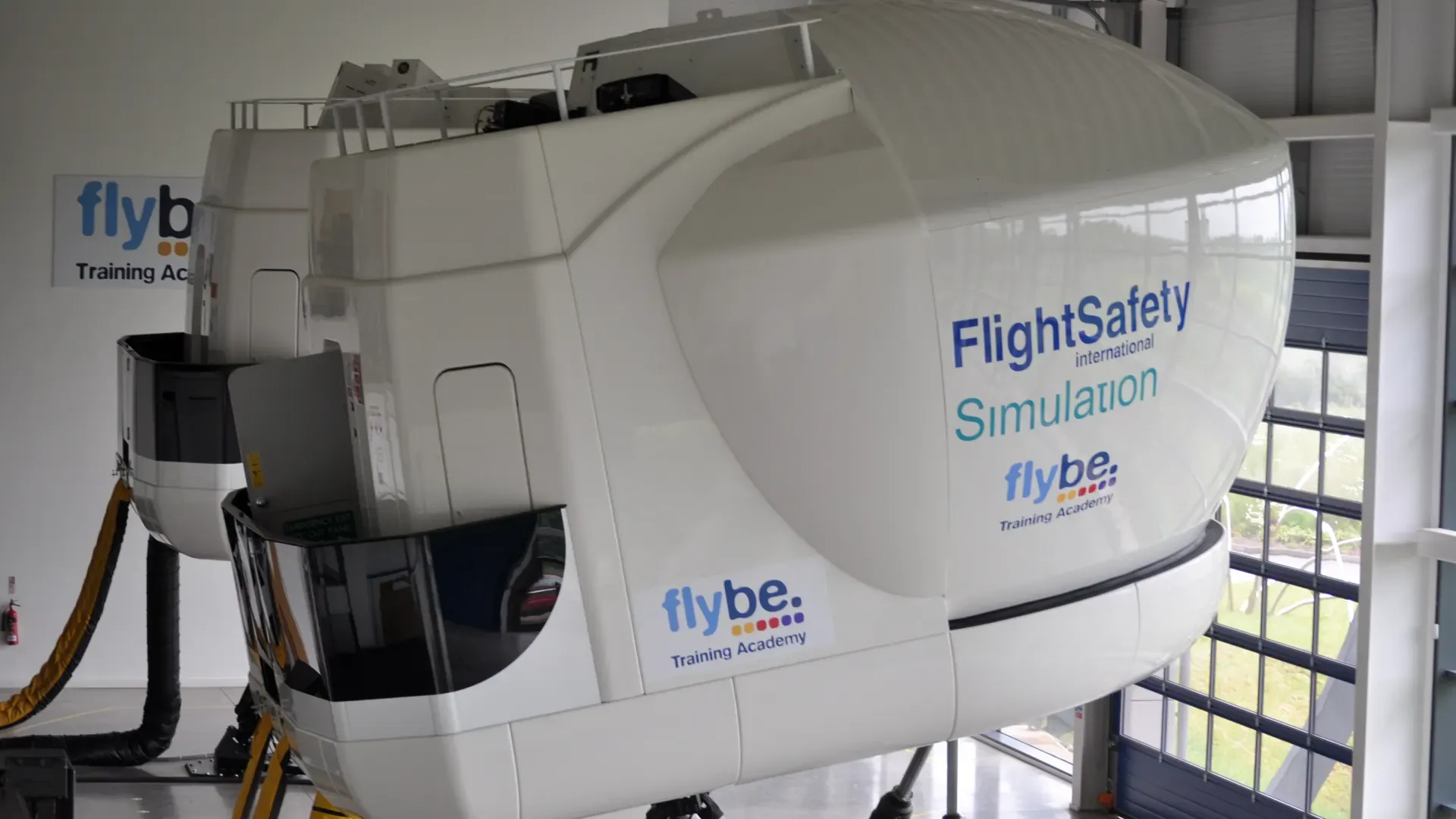 Aircraft flight simulator cockpit illustrating airline emergency procedures training