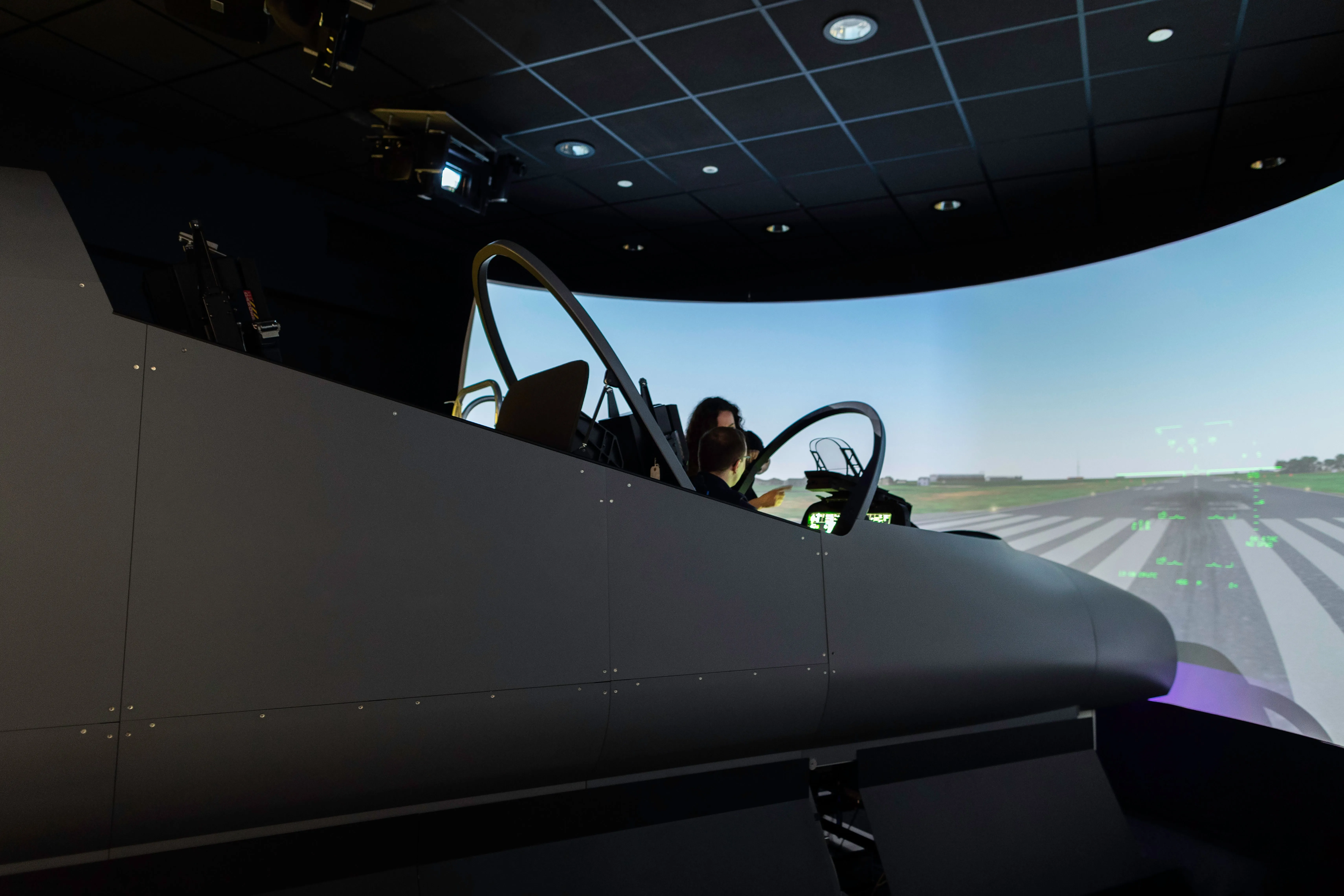 Pilot training in a Level D flight simulator with advanced cockpit controls and digital displays