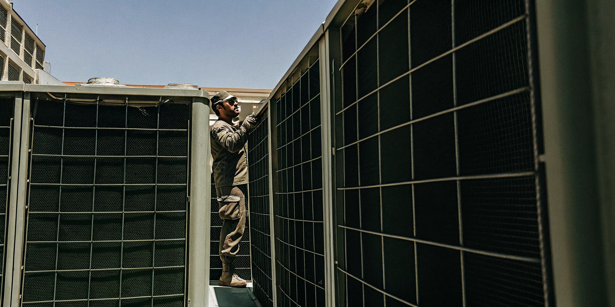 Commercial HVAC technician performing rooftop unit maintenance in San Antonio