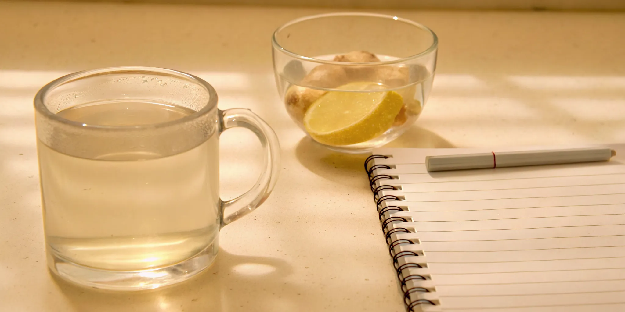Food journal, ginger tea, and water for a daily bloating relief routine