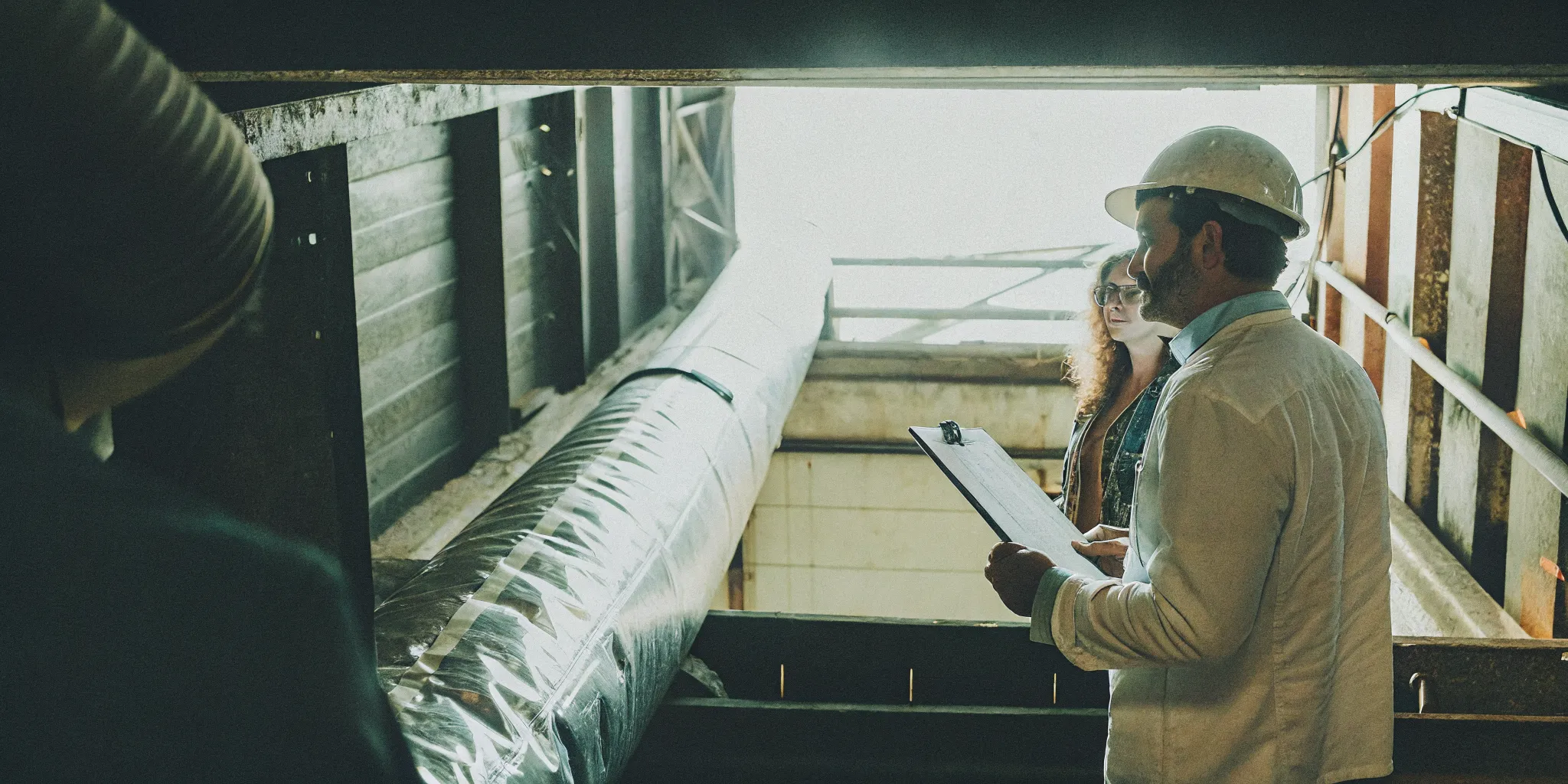 Environmental compliance audit checklist review inside a manufacturing facility