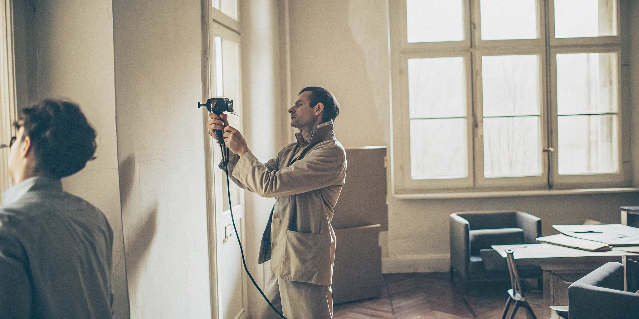 Environmental consultant using XRF device to test paint for lead during a commercial property survey