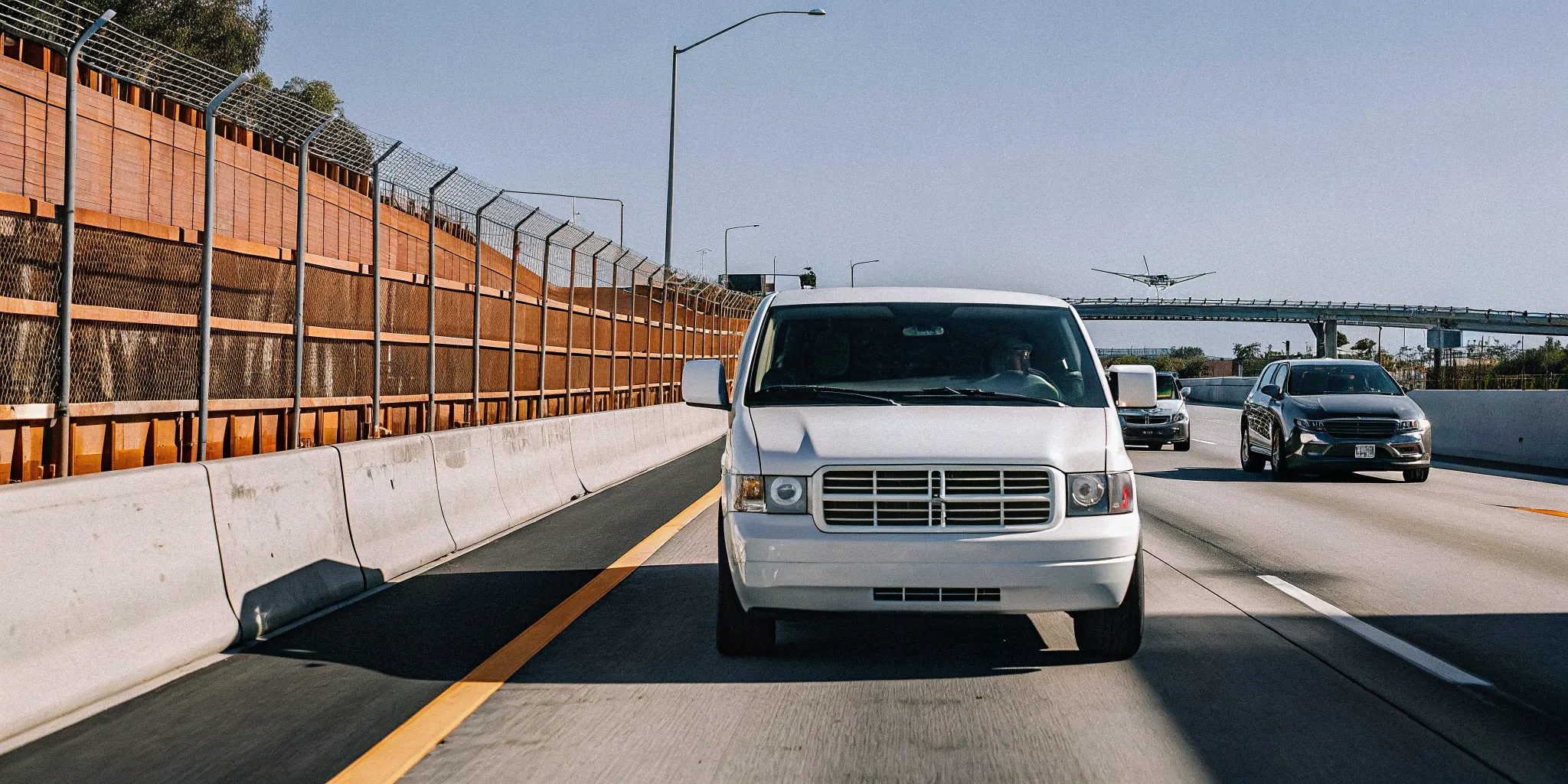 Private van driving on a Southern California freeway toward LAX during daytime traffic