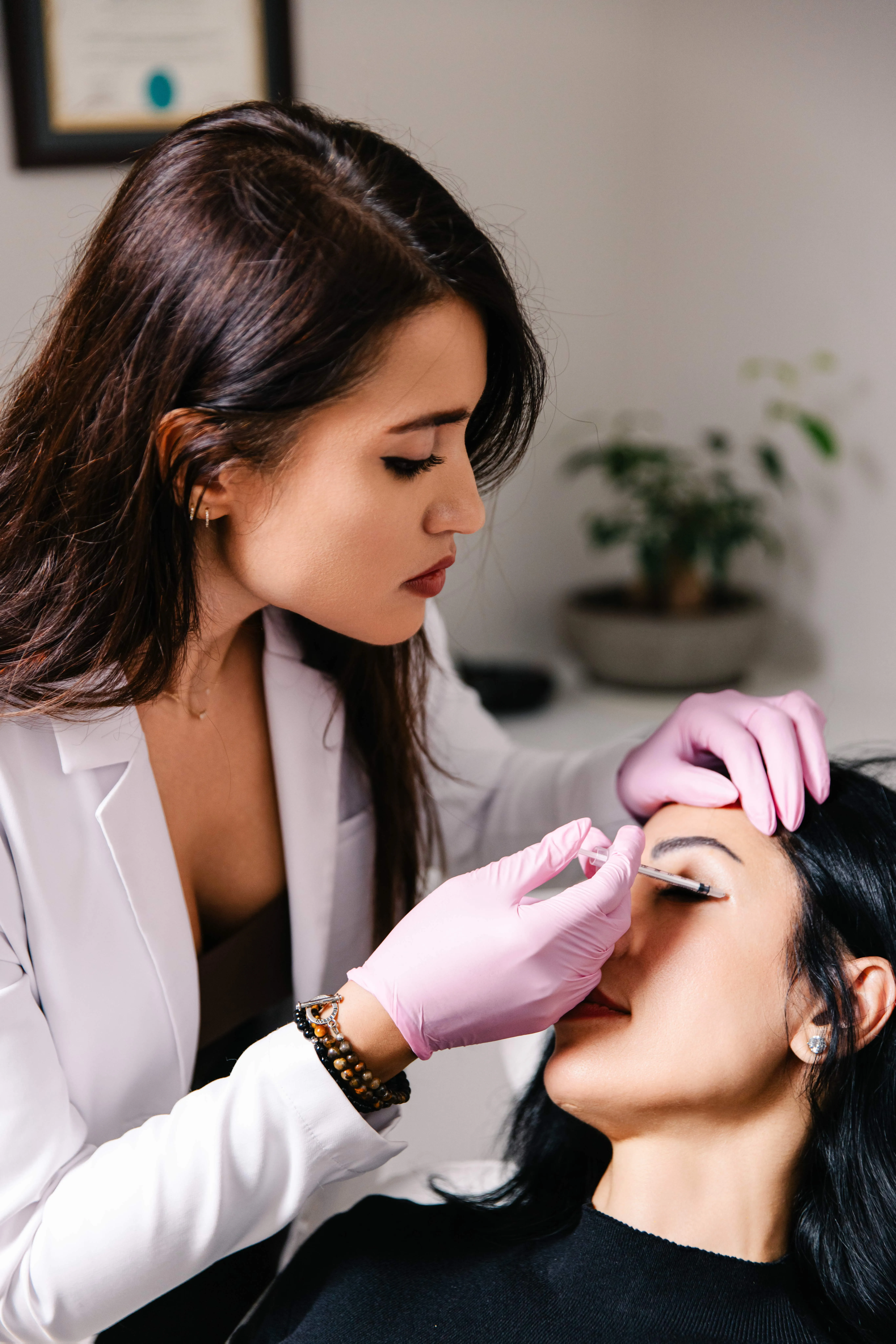 Provider preparing an injectable treatment for a client's face