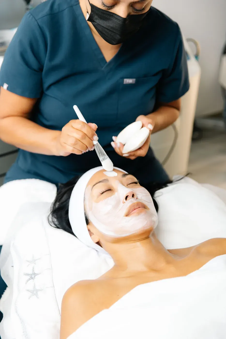 Client receiving a customized facial mask from the trained OCSC team
