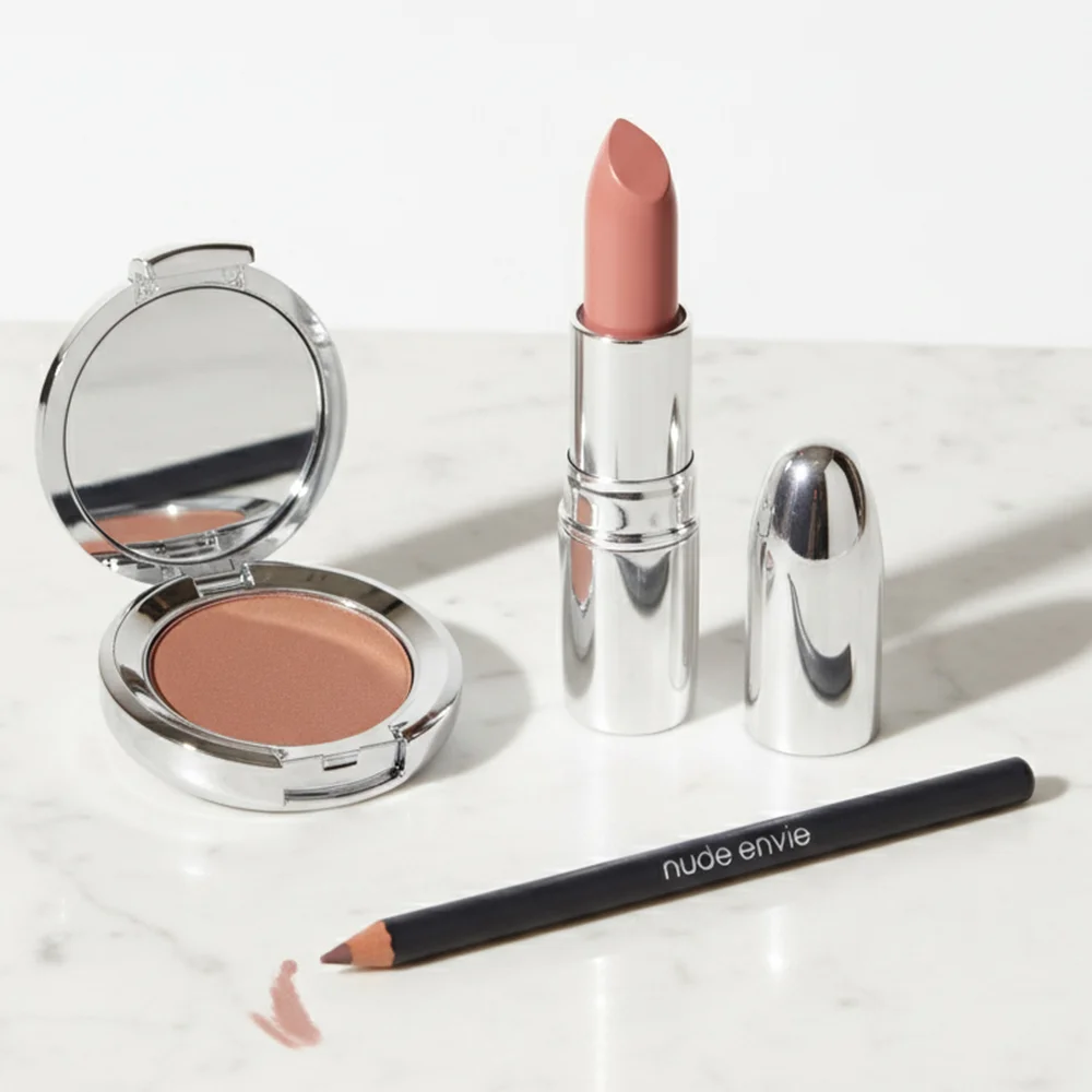 Elegant nude makeup product arrangement featuring a coordinated lip, eye, and cheek collection for gifting