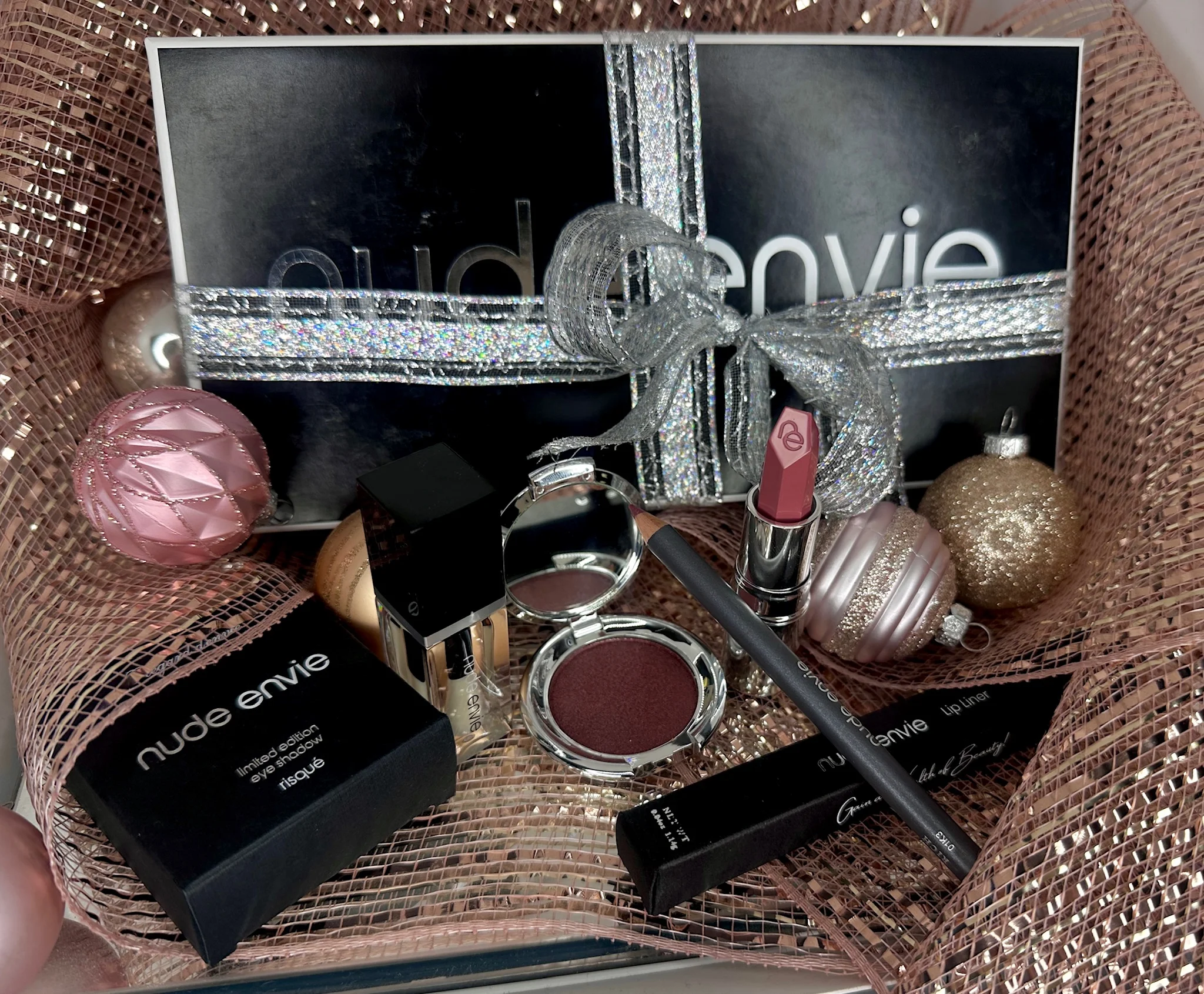 Nude Envie nail lacquer and coordinated nude beauty products arranged for a polished manicure